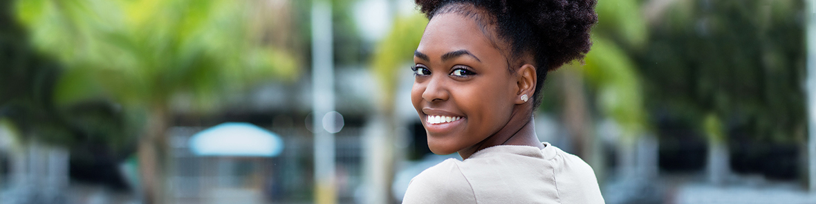 Female student smiling looking back over her shoulder