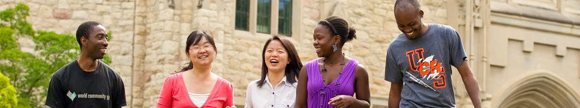 International students walking on campus smiling